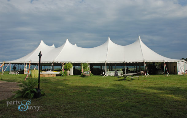 white pole tent reception with benches